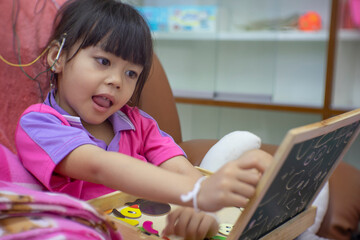Child with EEG sensors watching a movie during neurofeedback session